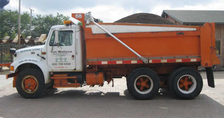 A large dump truck carrying soil